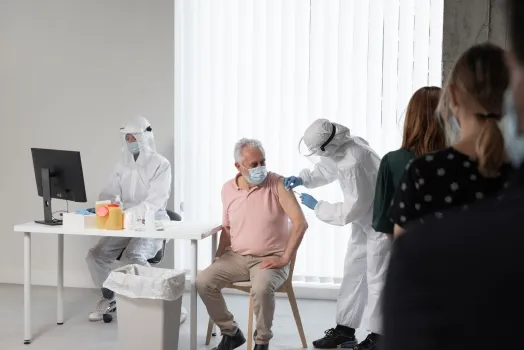 Doctor vaccinating a patient at a center